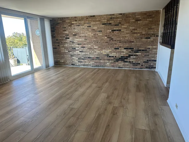 a view of water heater room with wooden floor