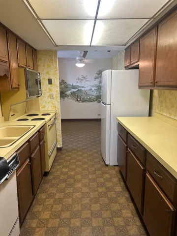 a kitchen with stainless steel appliances a stove microwave and sink