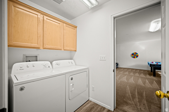1825 West Mathis Park Place, Unit 46 St. George, UT 84770 - Photo 30 of 45 Laundry area with cabinet space, washer and clothes dryer, and light wood-style floors