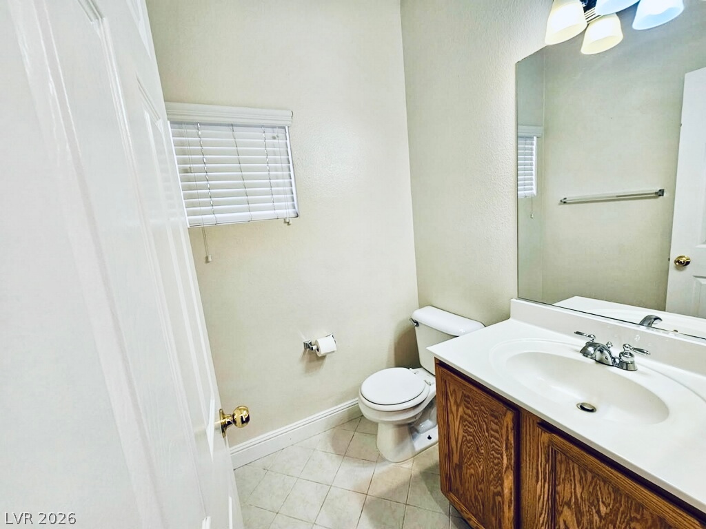 5953 Crumbling Ridge Street Henderson, NV 89011 - Photo 11 of 42 A well-appointed half bath features ample vanity space and essential fixtures for convenience.