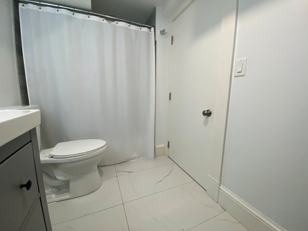 10 Gloucester Avenue, Unit B Gloucester, MA 01930 - Photo 12 of 13 a bathroom with a toilet and a shower