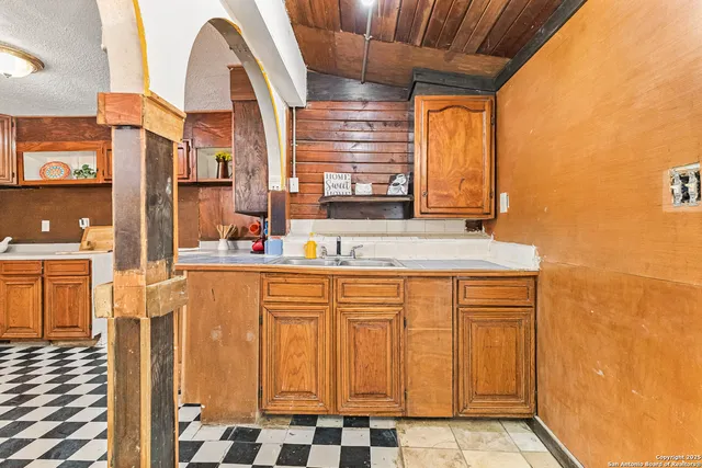 a bathroom with a sink a mirror and shower