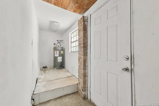 a bedroom with a white bed and white walls