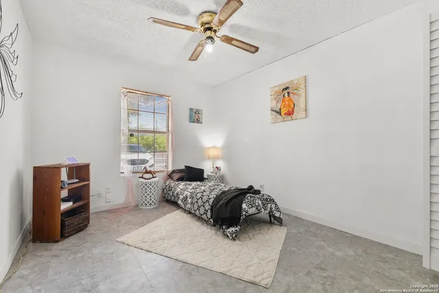 a bedroom with a bed and a lamp