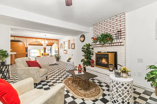 a living room with furniture large window and a fireplace