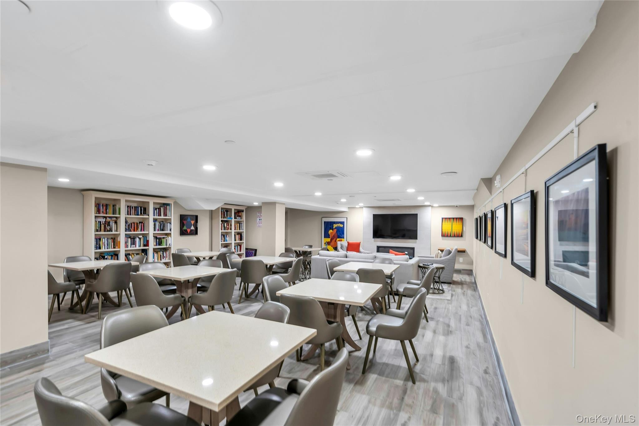2 Richmond Road, Unit 5W Lido Beach, NY 11561 - Photo 28 of 42 Spacious common area featuring guest, remote work options. Kitchenette, living area, recessed lighting, built-in shelving, and wall-mounted artwork ideal to expand your home's space.
