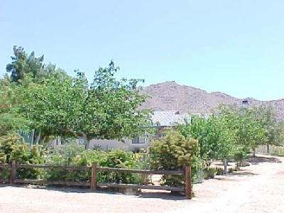 23444 Tokata Road Apple Valley, CA 92307 - Photo 1 of 1 a view of a street with a building in the background