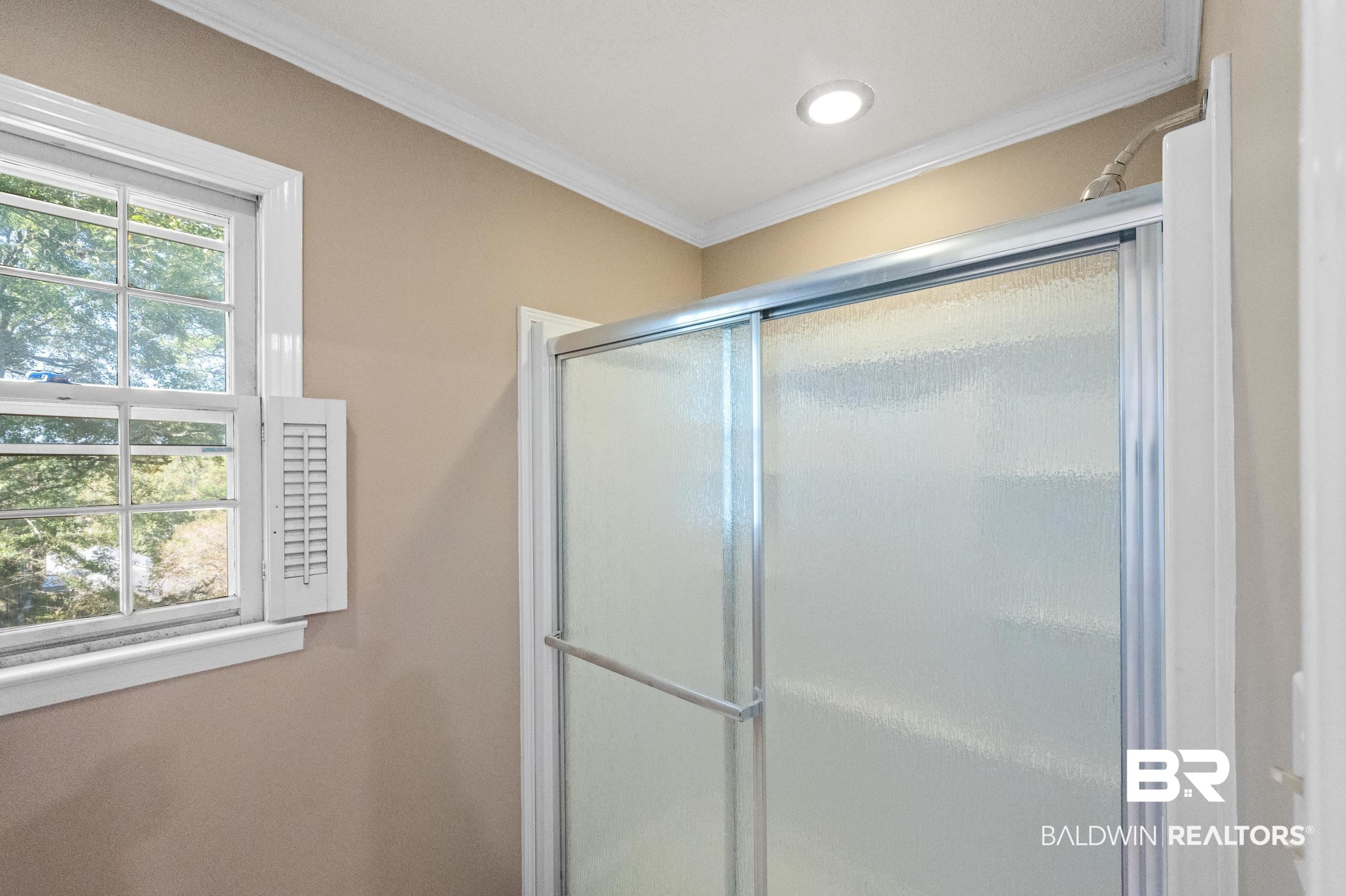 6705 Ridgeland Road South Mobile, AL 36695 - Photo 26 of 44 Bathroom featuring ornamental molding and an enclosed shower