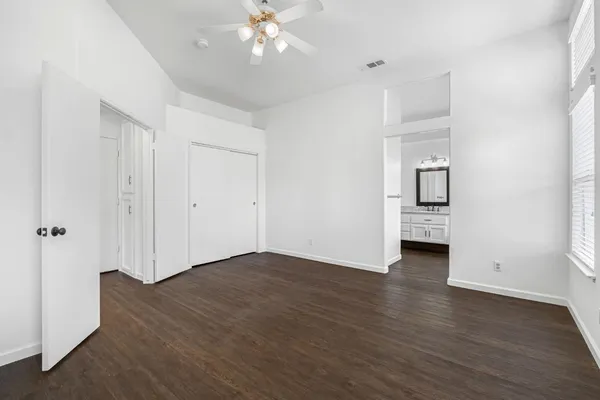 a view of an empty room with wooden floor