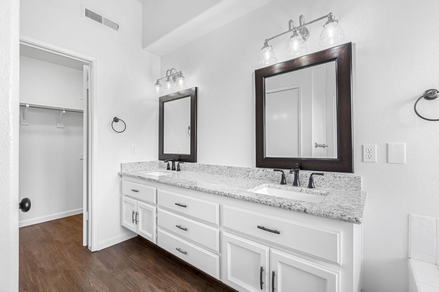 265 West Decatur Avenue Clovis, CA 93611 - Photo 15 of 19 a bathroom with a granite countertop sink double and mirror