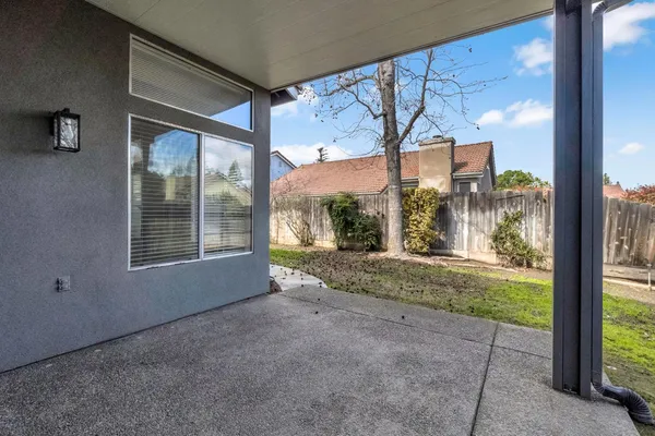 a view of a house with backyard and porch