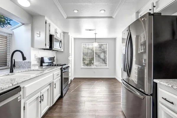 a kitchen with stainless steel appliances a refrigerator sink and microwave