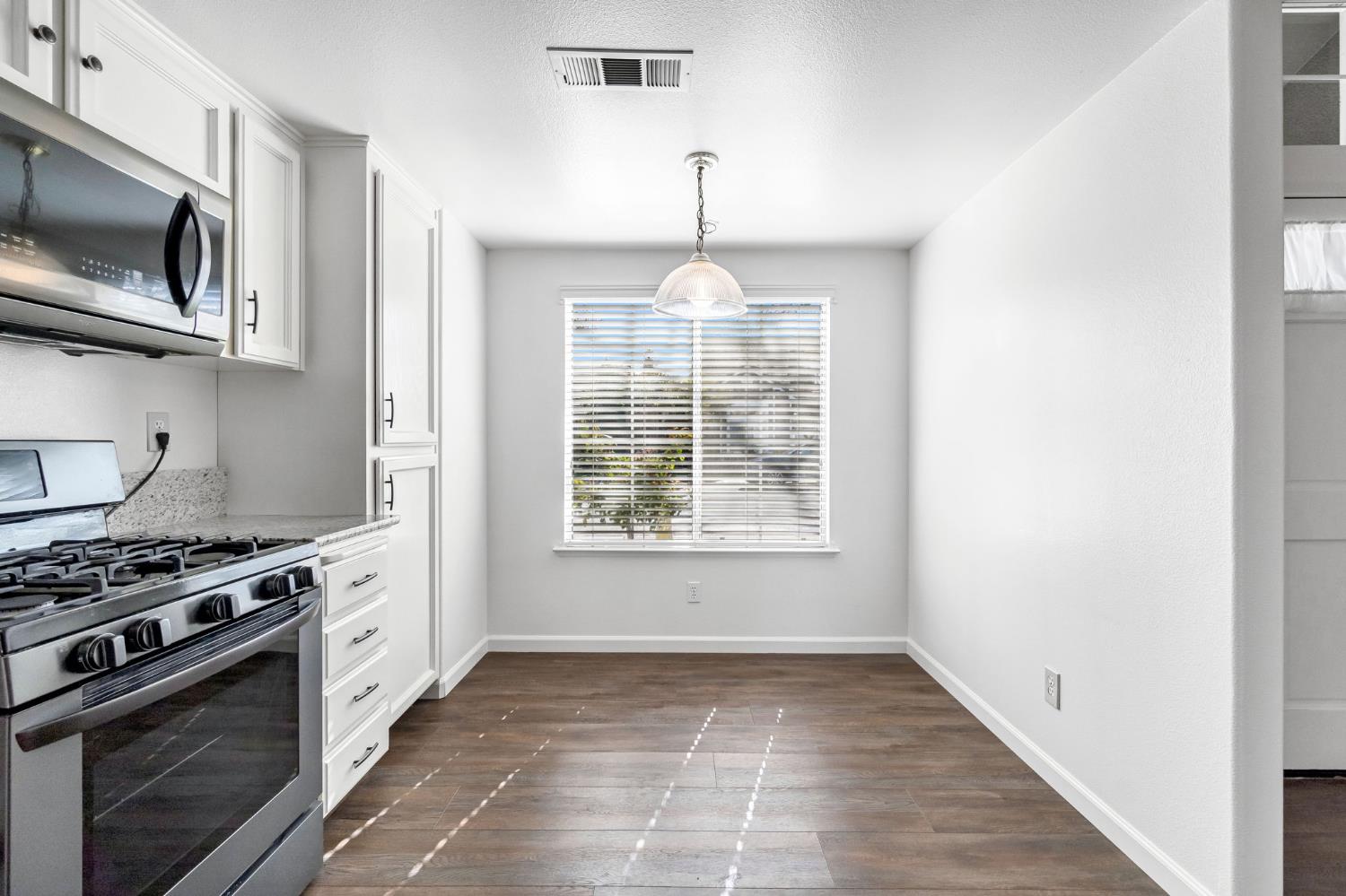 265 West Decatur Avenue Clovis, CA 93611 - Photo 7 of 19 a kitchen with a stove a microwave and window