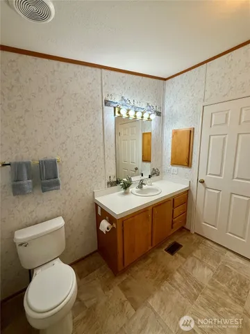 a bathroom with a sink toilet and mirror