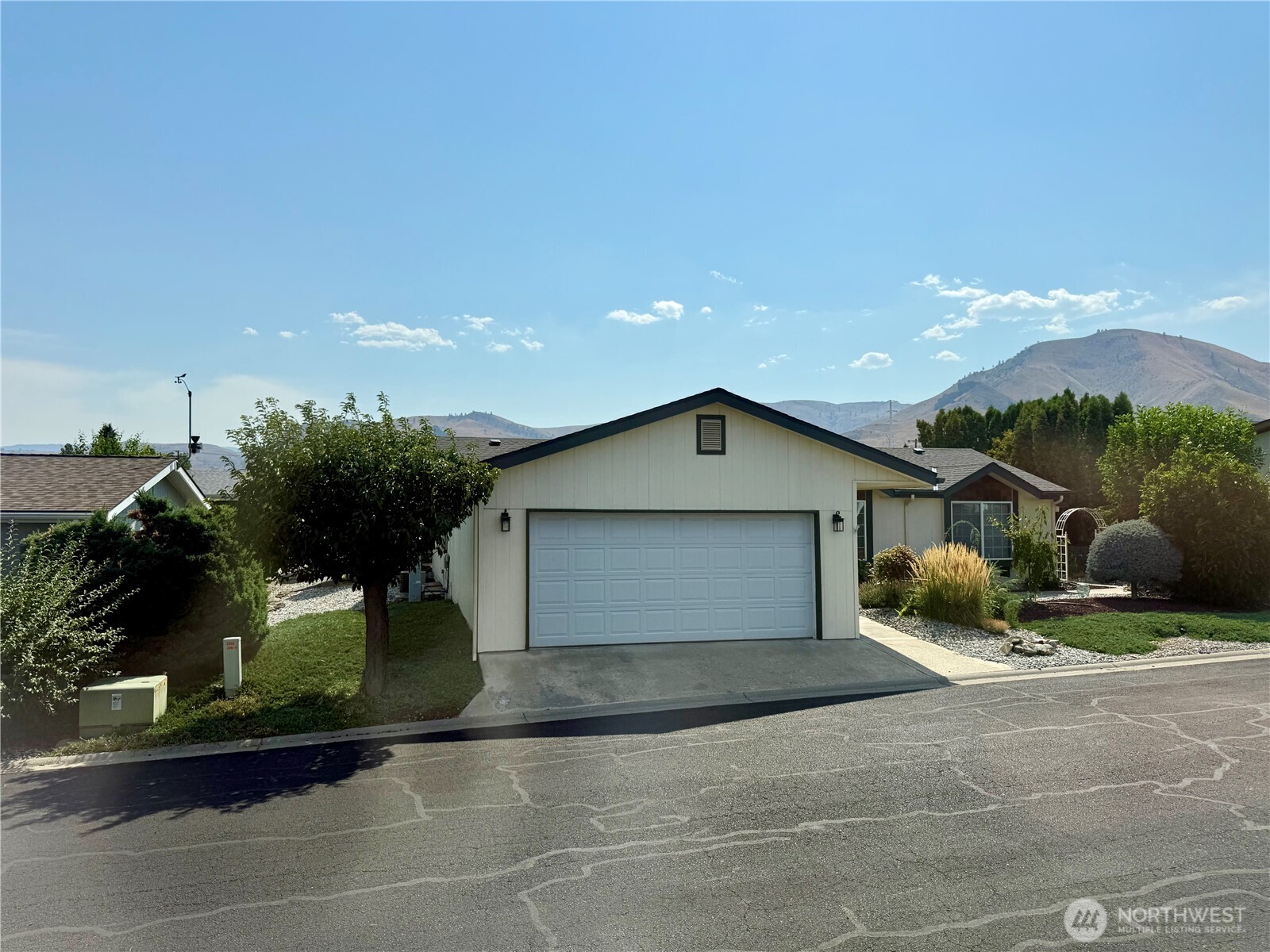 1628 Pleasant Avenue Wenatchee, WA 98801 - Photo 24 of 24 a view of a house with backyard and bushes