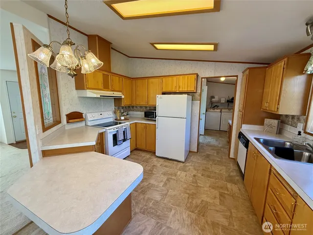 a kitchen with refrigerator and window