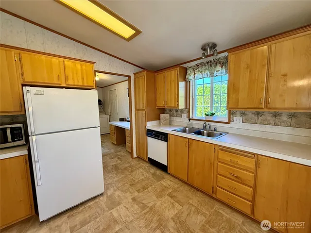 a kitchen with sink a refrigerator and a sink