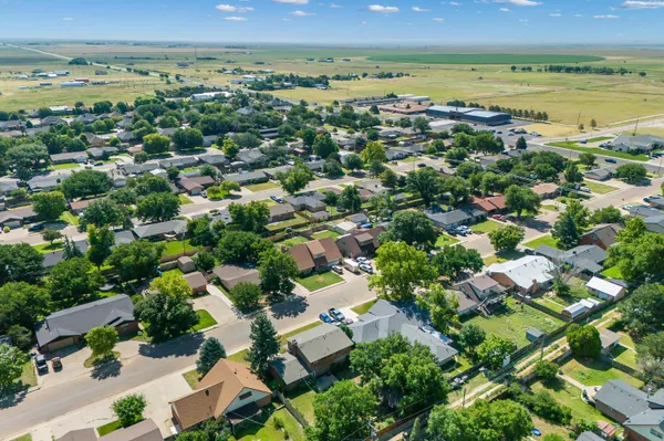 an aerial view of residential house with outdoor space and trees