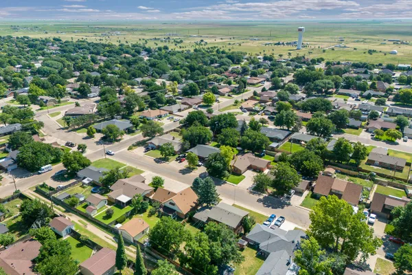 an aerial view of residential houses with outdoor space
