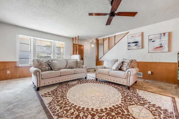 a living room with furniture and a rug