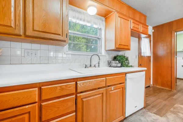 a kitchen with stainless steel appliances granite countertop a sink and a window