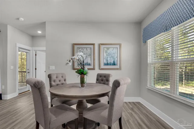 a view of a dining room with furniture and wooden floor
