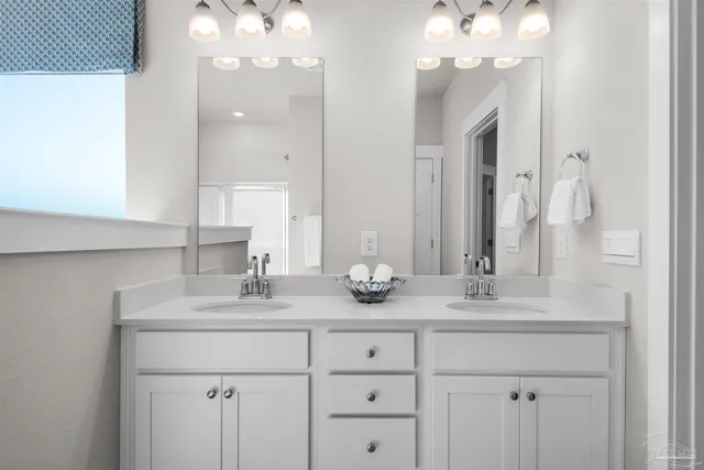 a bathroom with a sink double vanity and a mirror