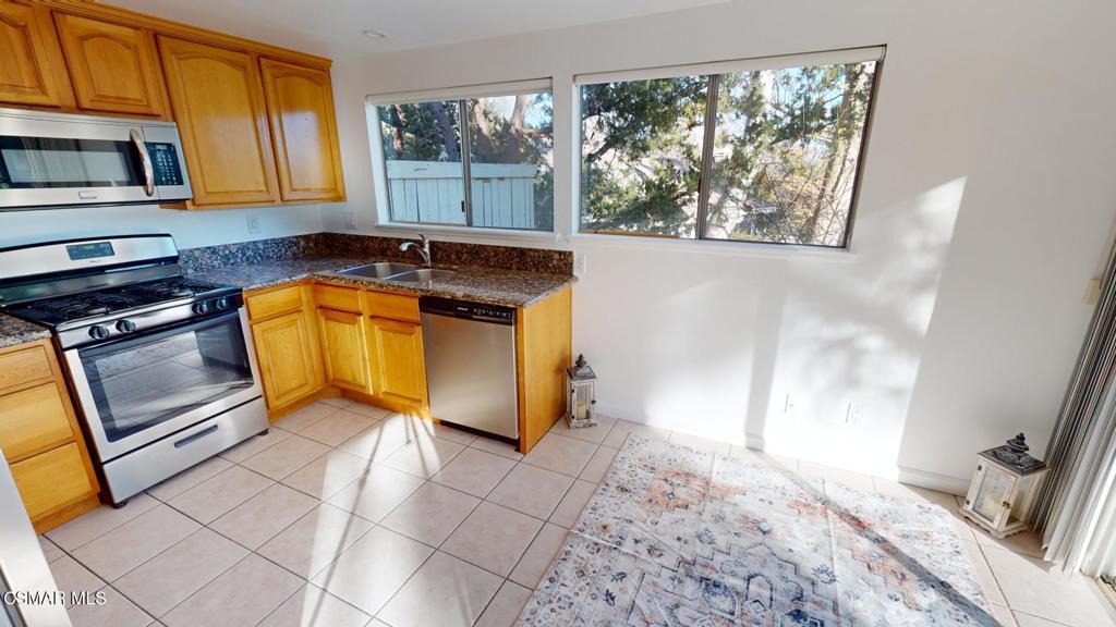 157 Conifer Circle Oak Park, CA 91377 - Photo 13 of 21 a kitchen with stainless steel appliances granite countertop a stove a sink and a microwave