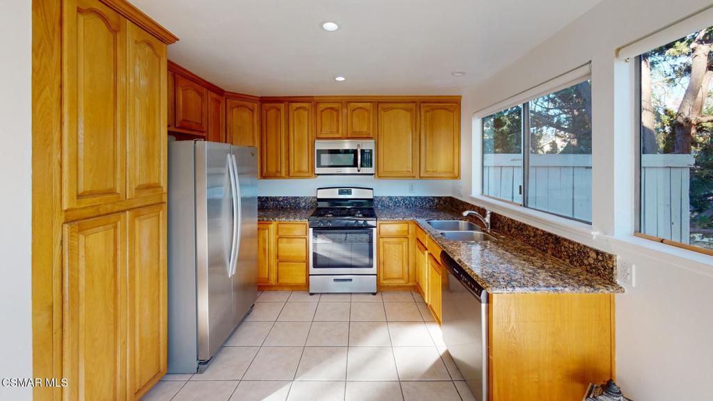 157 Conifer Circle Oak Park, CA 91377 - Photo 14 of 21 a kitchen with stainless steel appliances granite countertop a refrigerator and a stove top oven