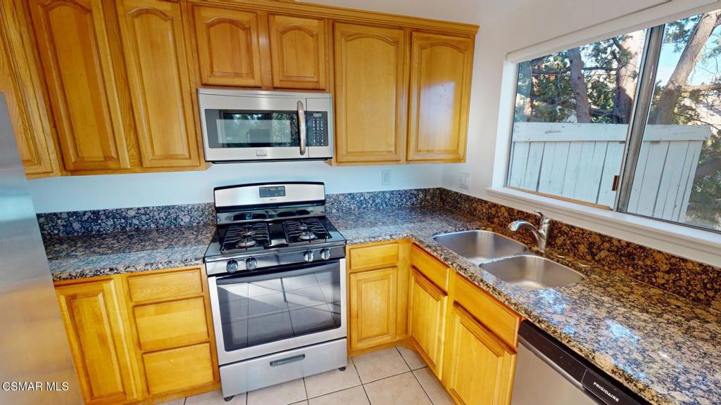 157 Conifer Circle Oak Park, CA 91377 - Photo 15 of 21 a kitchen with granite countertop cabinets and window
