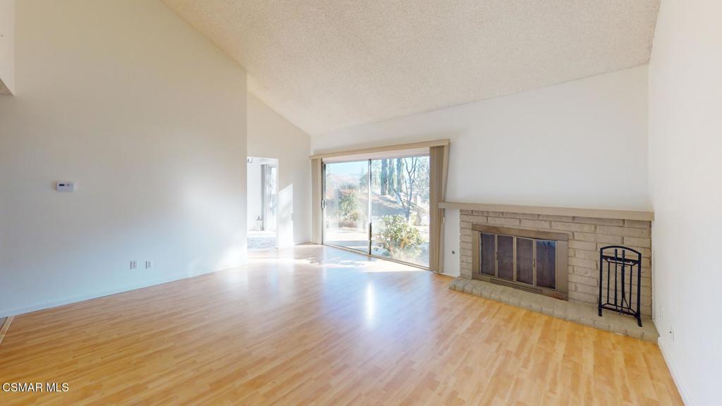 157 Conifer Circle Oak Park, CA 91377 - Photo 4 of 21 a view of an empty room with wooden floor and a window