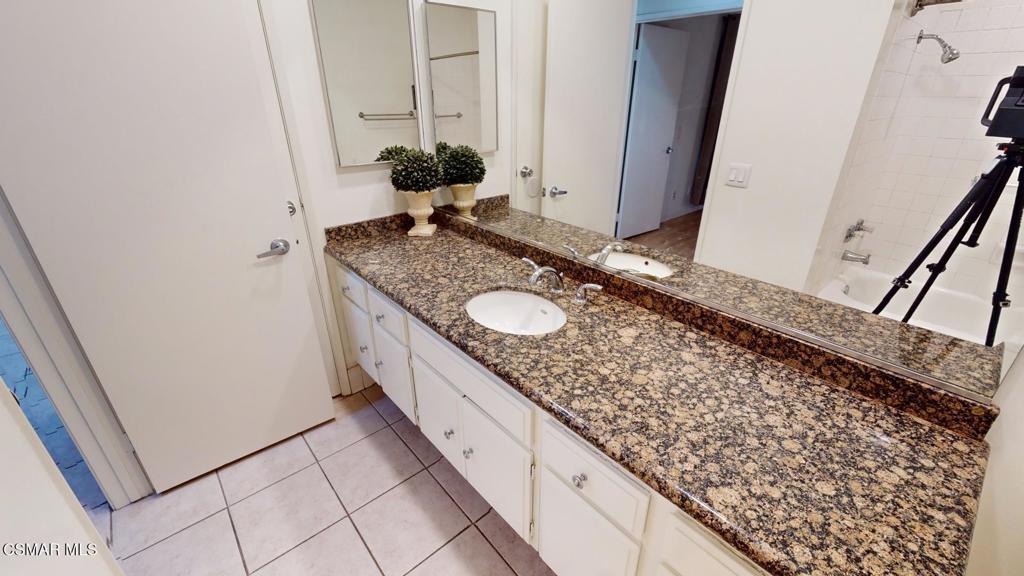157 Conifer Circle Oak Park, CA 91377 - Photo 8 of 21 a bathroom with a granite countertop sink and a mirror