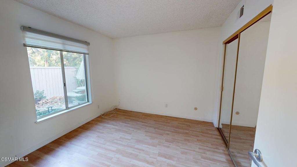 157 Conifer Circle Oak Park, CA 91377 - Photo 10 of 21 an empty room with wooden floor and windows