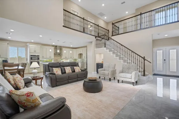 a kitchen with a sink a stove a refrigerator and white cabinets with wooden floor