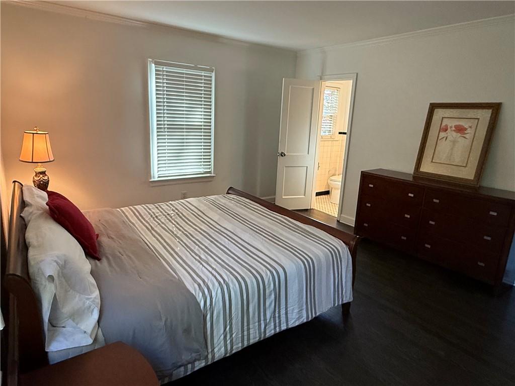 1140 Goodwin Place Northeast, Unit 4 Atlanta, GA 30319 - Photo 18 of 50 a bedroom with a bed and wooden floor