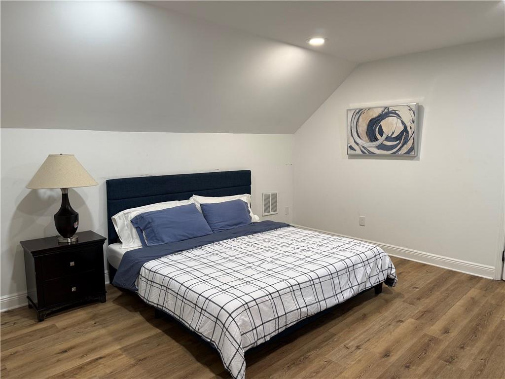 1140 Goodwin Place Northeast, Unit 4 Atlanta, GA 30319 - Photo 32 of 50 a bedroom with a bed and a night stand