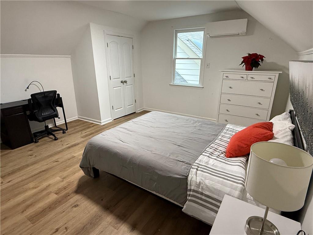 1140 Goodwin Place Northeast, Unit 4 Atlanta, GA 30319 - Photo 41 of 50 a bedroom with a bed and wooden floor