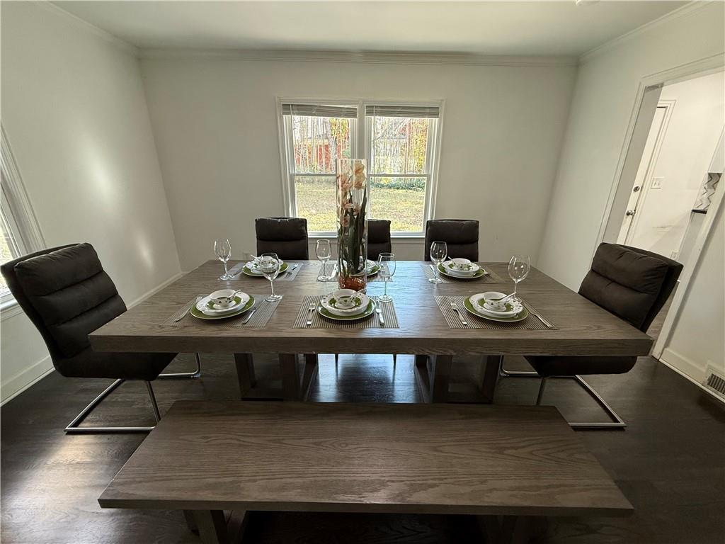 1140 Goodwin Place Northeast, Unit 4 Atlanta, GA 30319 - Photo 6 of 50 a view of a dining room with furniture and wooden floor