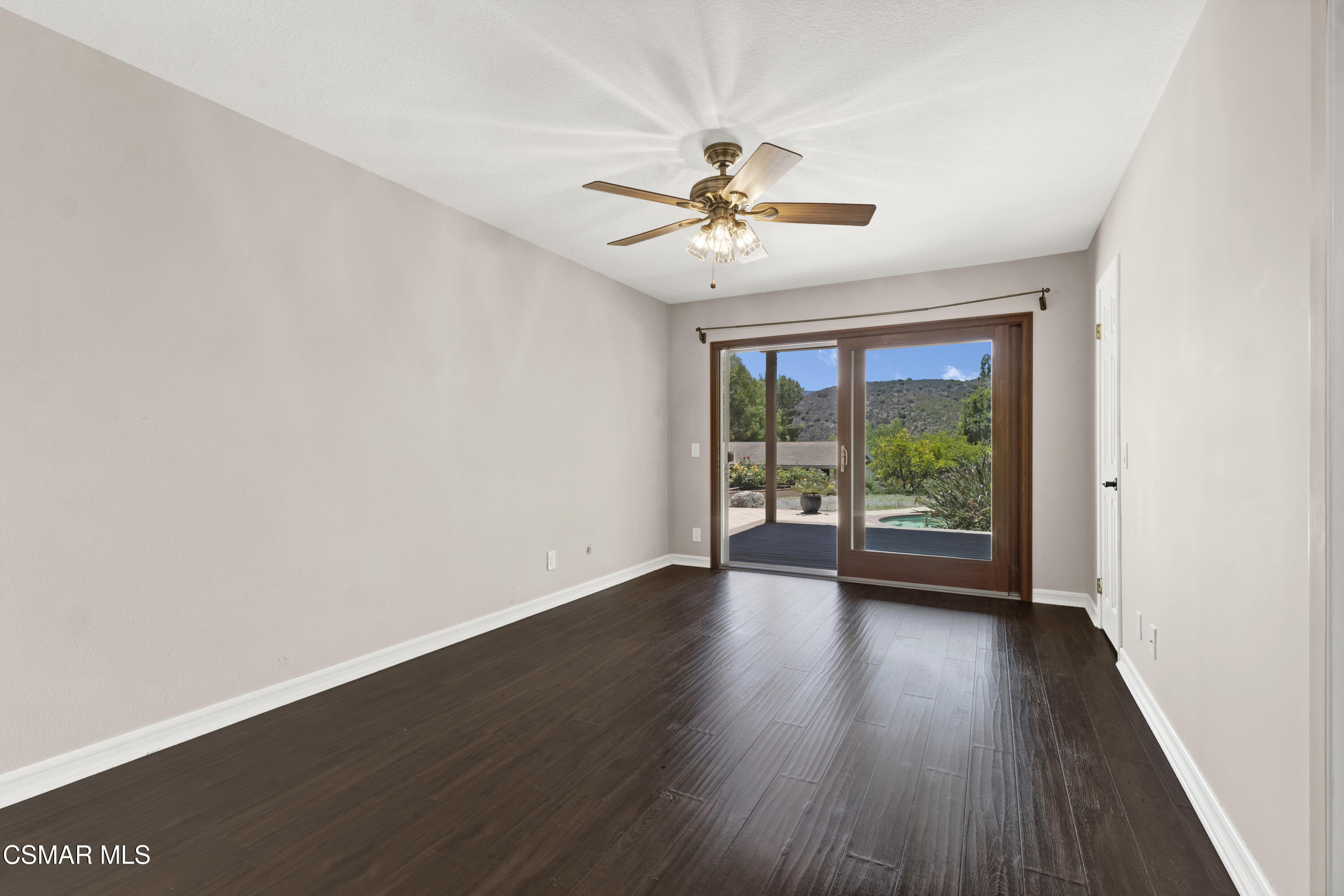 1506 Rambling Road Simi Valley, CA 93065 - Photo 17 of 79 a view of an empty room with wooden floor and a window