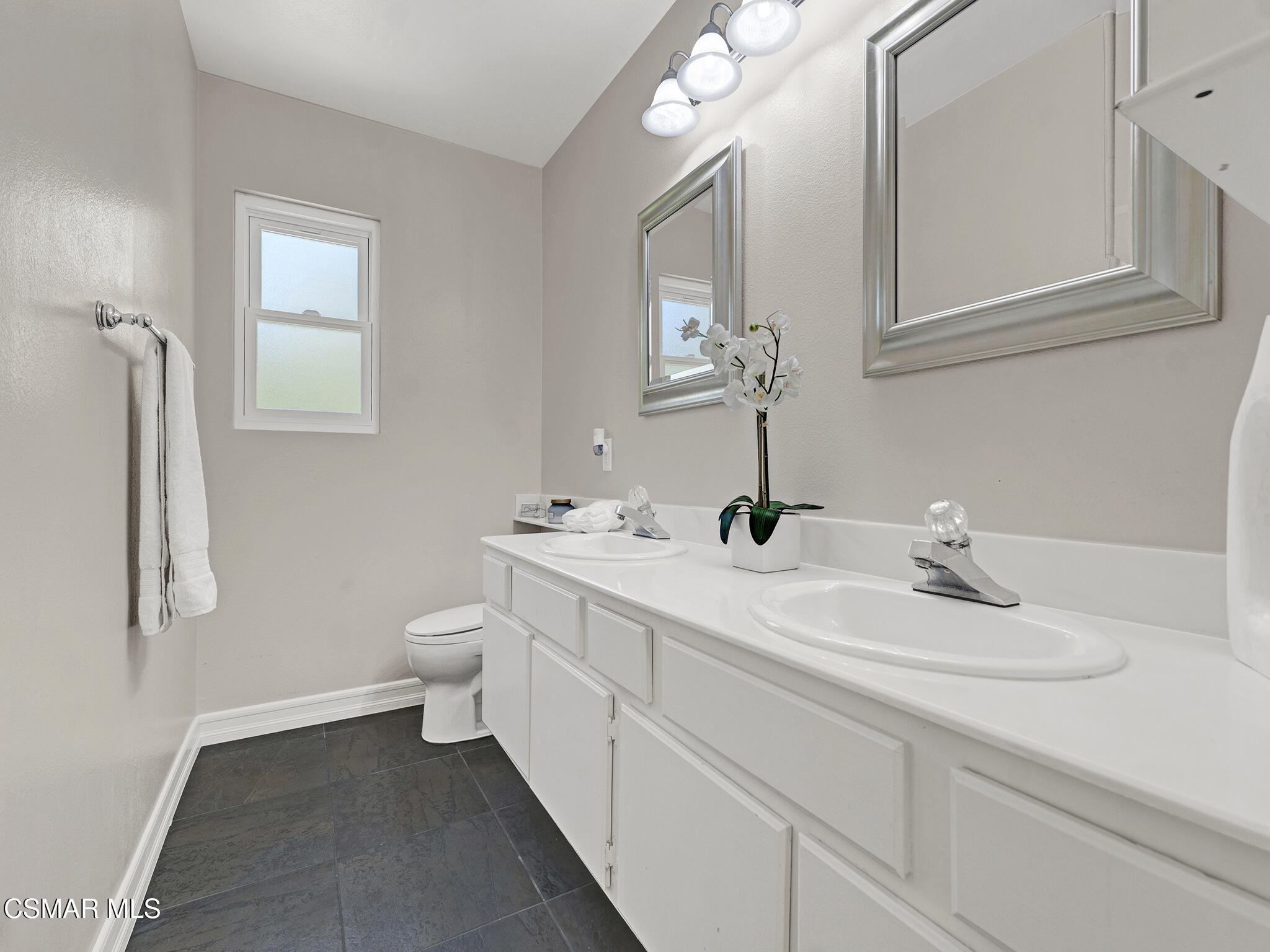 1506 Rambling Road Simi Valley, CA 93065 - Photo 23 of 79 a bathroom with a toilet sink and mirror