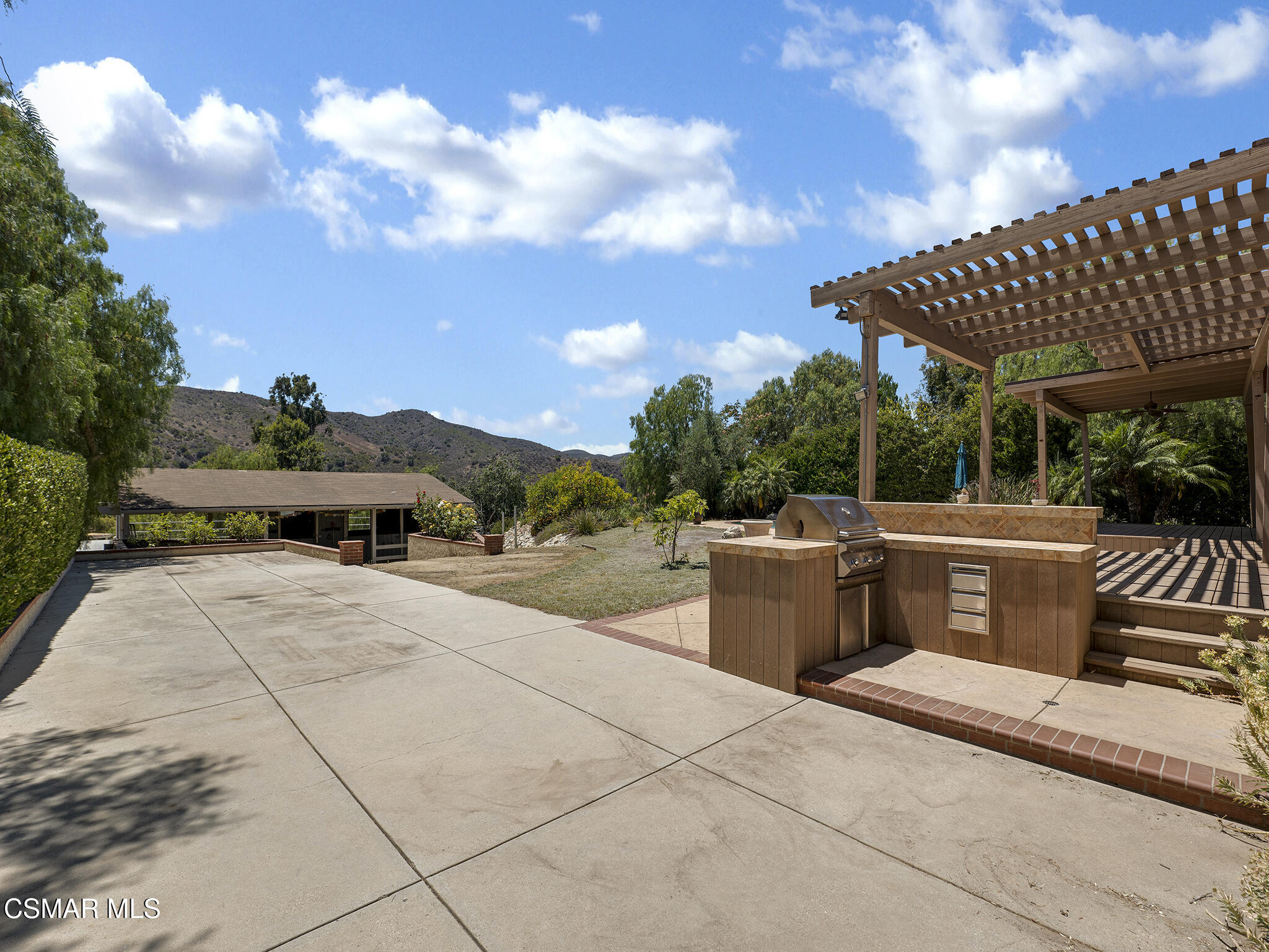 1506 Rambling Road Simi Valley, CA 93065 - Photo 32 of 79 a view of a patio with couches table and chairs and potted plants