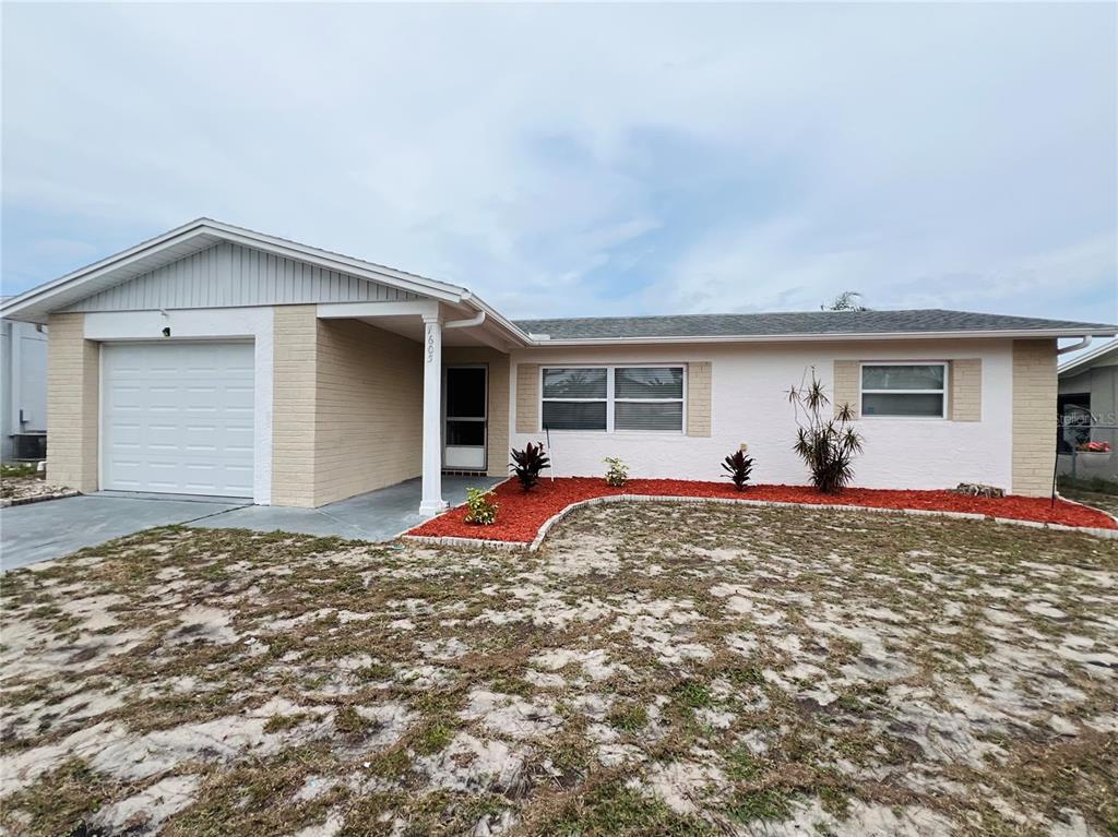 7605 Foxbloom Drive Port Richey, FL 34668 - Photo 1 of 1 a view of a house with backyard and porch