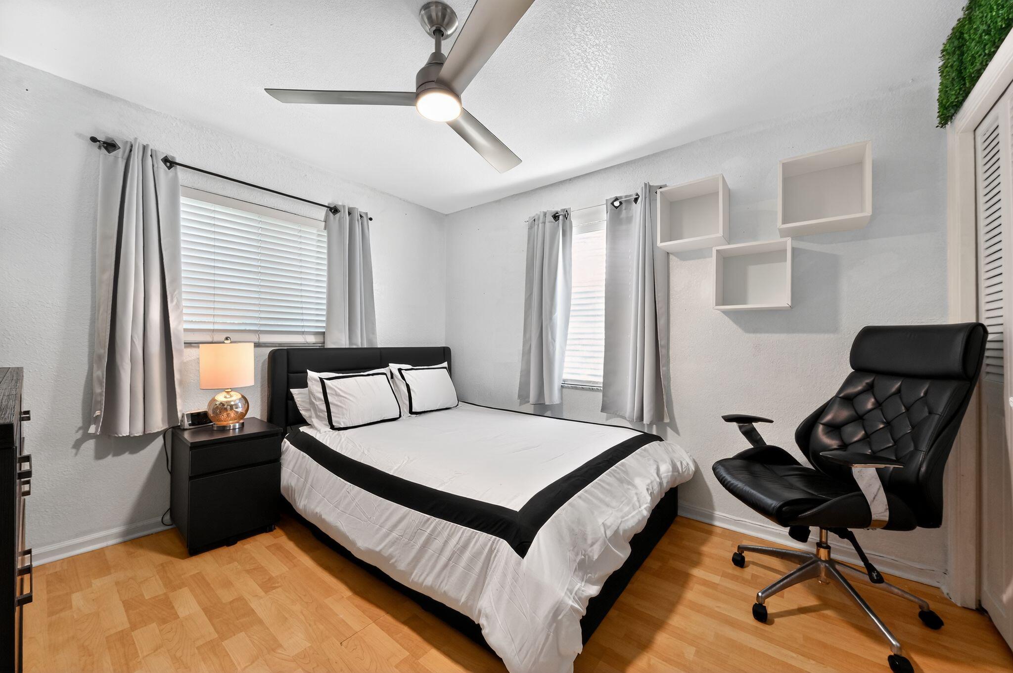 407 Highwood Circle Jupiter, FL 33458 - Photo 22 of 30 a large bed sitting in a bedroom next to a window