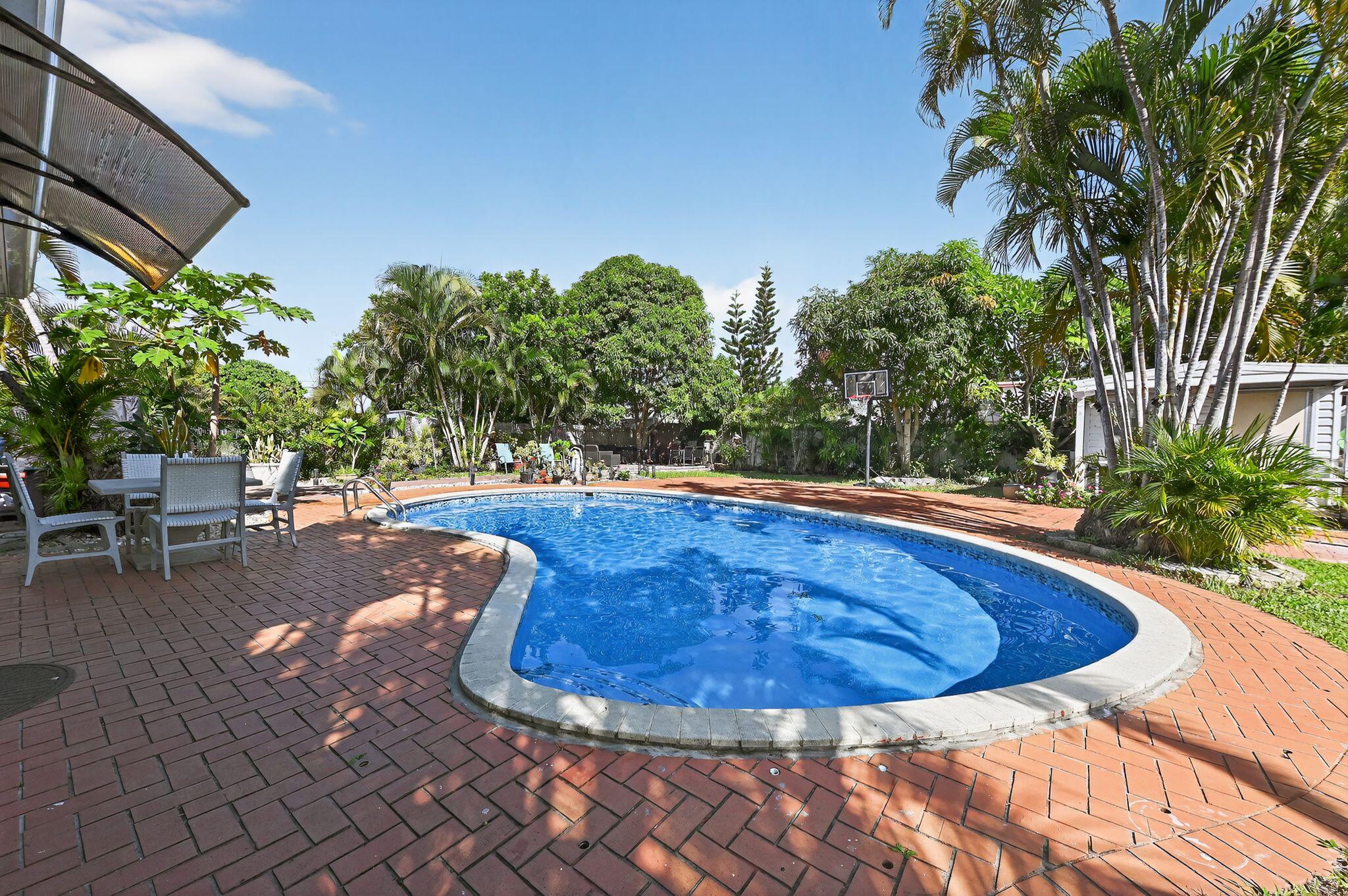 407 Highwood Circle Jupiter, FL 33458 - Photo 26 of 30 a view of a swimming pool with chairs