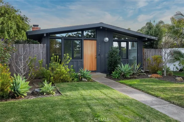 a front view of house with a garden