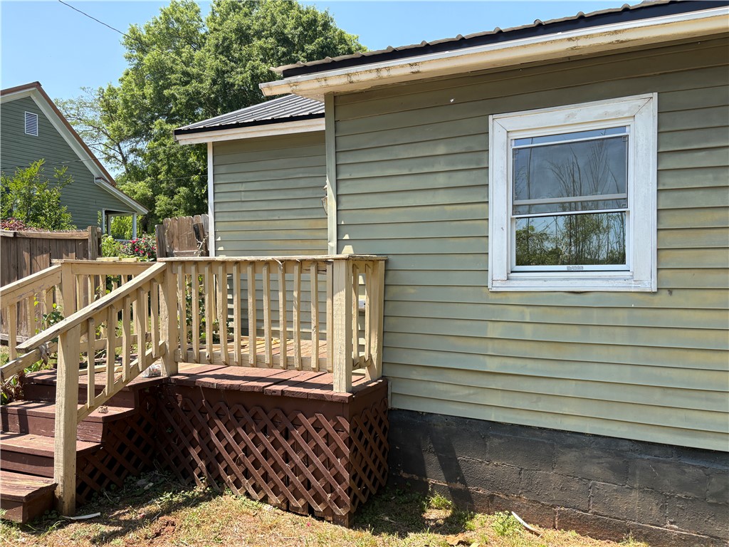 1309 Gilmer Street Anderson, SC 29621 - Photo 5 of 15 This charming residence features classic siding and a welcoming wooden deck, perfect for outdoor enjoyment.