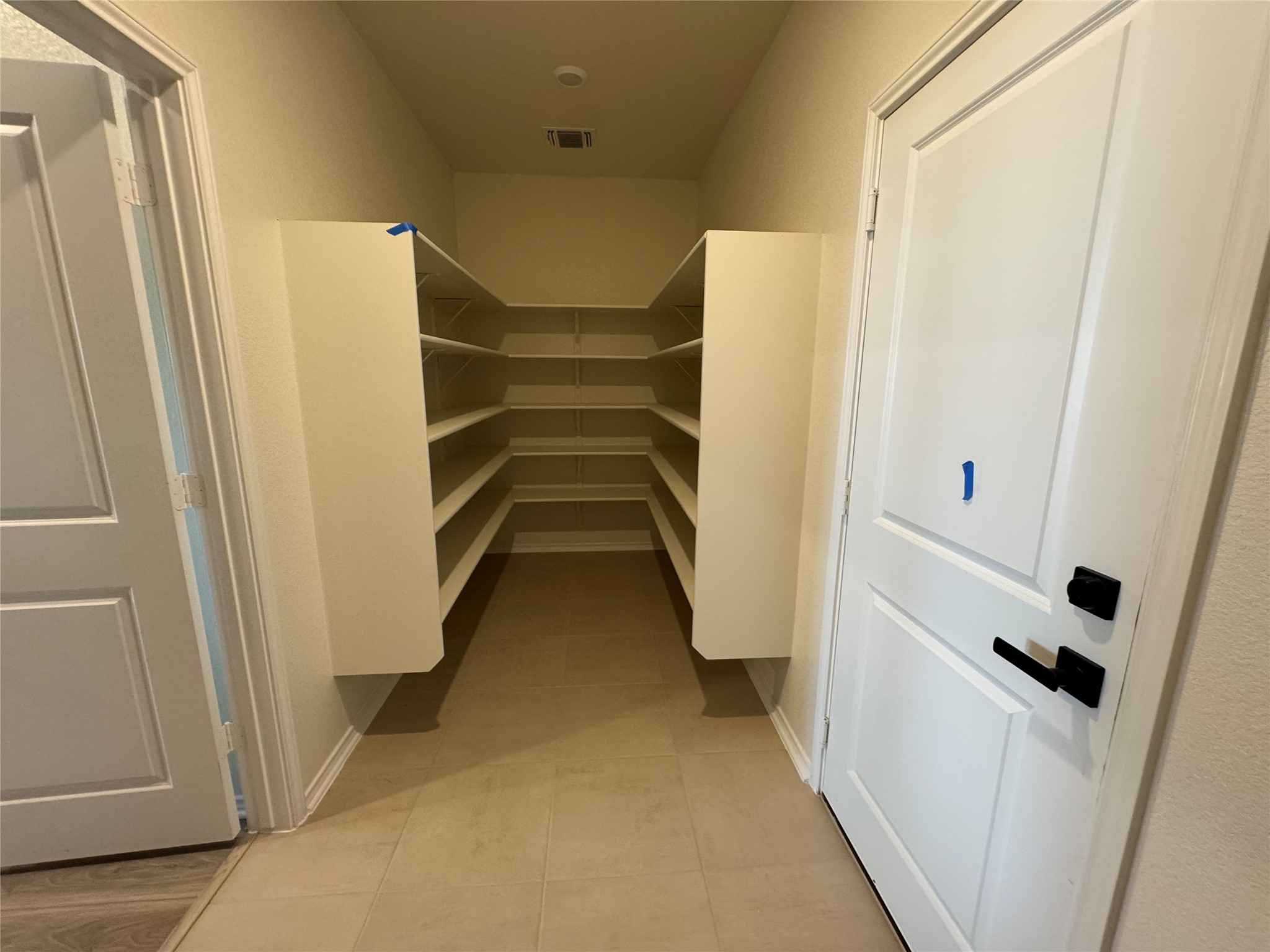 216 Coastal Way Georgetown, TX 78628 - Photo 18 of 38 a view of walk in closet with empty racks
