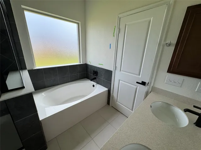 a view of a living room with wooden floor and a ceiling fan