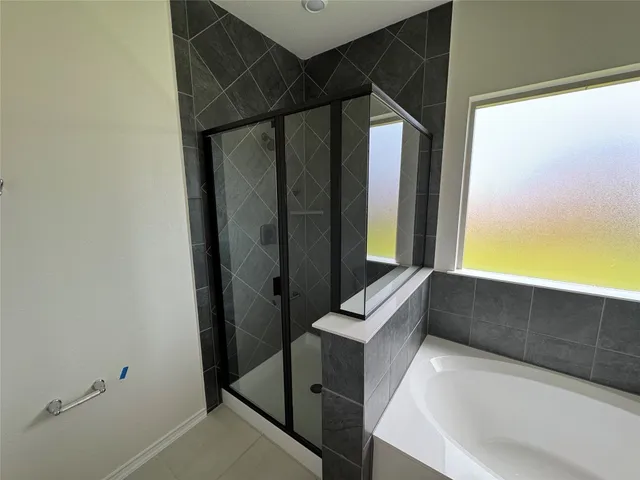 a bathroom with a tub a sink and a vanity
