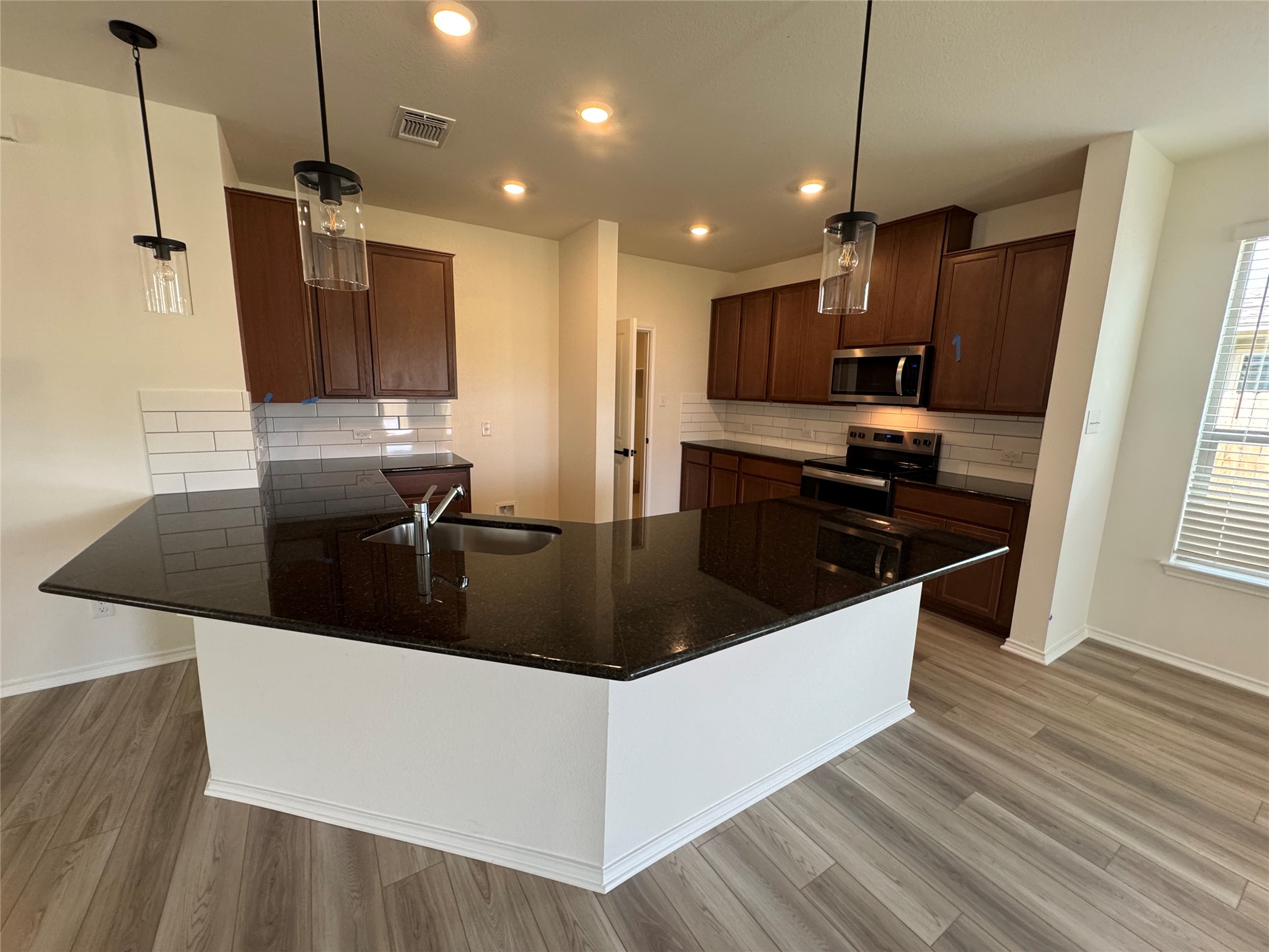 216 Coastal Way Georgetown, TX 78628 - Photo 34 of 38 a kitchen with stainless steel appliances granite countertop a sink a stove and a refrigerator